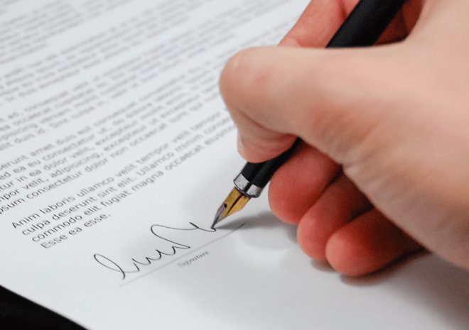 Signing a legal document - KLM Solicitors Sunshine Coast
